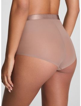 Modelo con braga faja Spanx Sheer Smoothing en color tostado, vista de espalda.